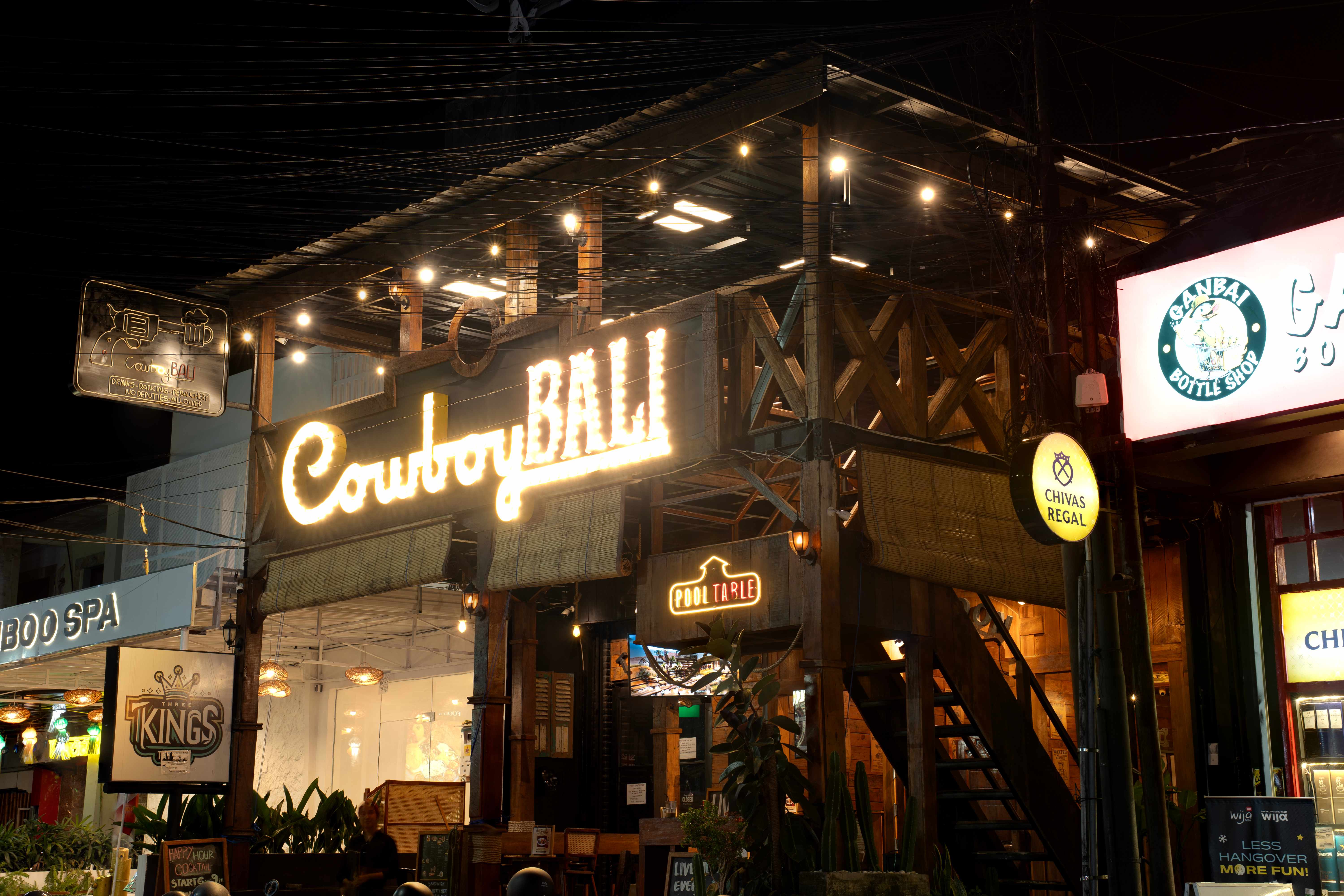 Cowboy Bali exterior with illuminated neon sign at night