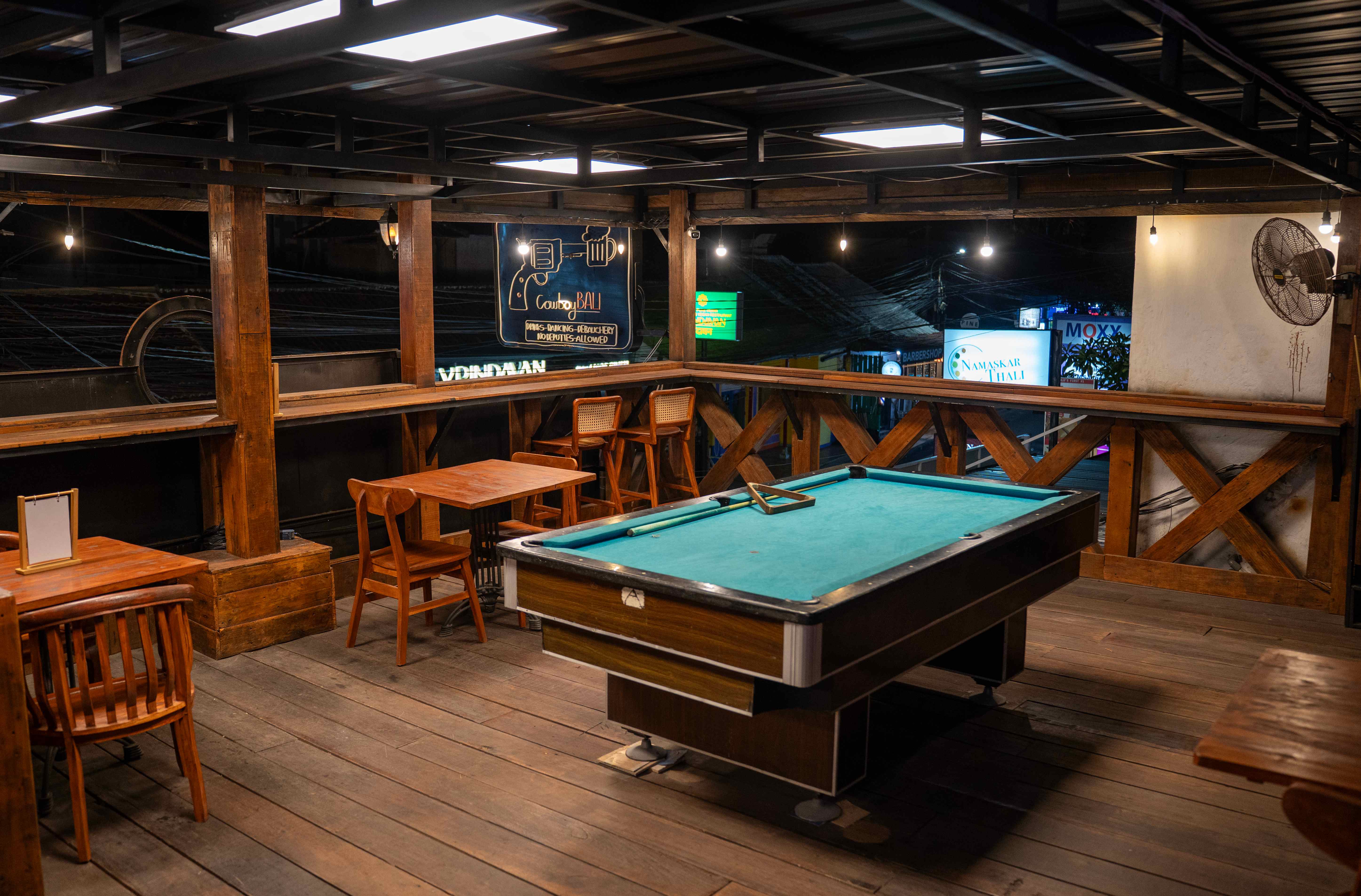 Upper level lounge with pool table and open-air seating